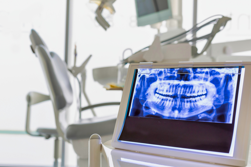 empty dental chair with xray in foreground